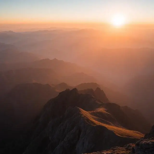 Expansive mountain range at sunrise.