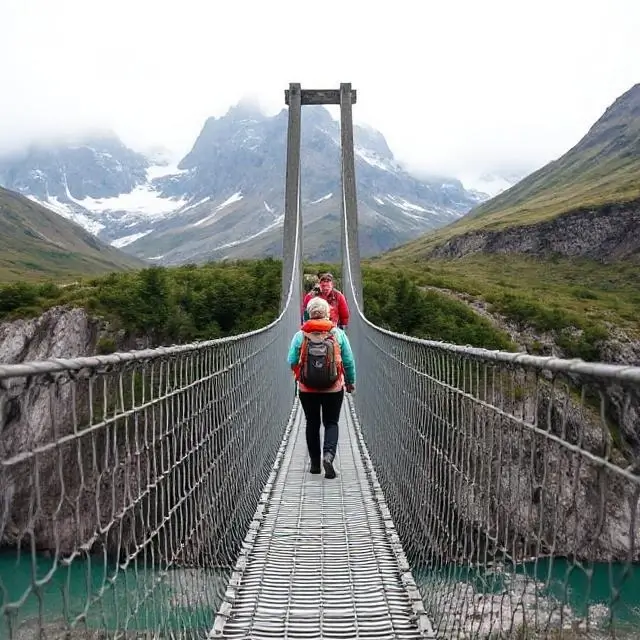 Hikers on a suspension bridge in Patagonia.